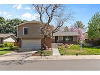 Charming home with a mature tree, brick accents, and an attached two-car garage at 3970 S Syracuse Way, Denver, CO 80237