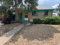 Charming single-story home with unique rock landscaping and eye-catching turquoise trim at 3531 Forest St, Denver, CO 80207