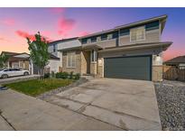 Two-story home featuring stone accents, neutral siding, and a two car garage at 4644 Hatcher Dr, Brighton, CO 80601
