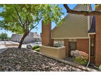 Charming brick townhouse with a well-maintained front yard and mature landscaping at 3300 W Florida Ave # 26, Denver, CO 80219