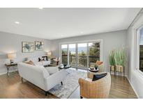 Bright living room featuring hardwood floors, mountain views, and neutral furnishings at 258 Post Boy Rd, Boulder, CO 80302