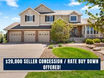 Charming two-story home featuring a three-car garage, landscaped front yard, and inviting entryway at 27290 E Nova Cir, Aurora, CO 80016