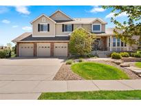 Charming two-story home featuring a three-car garage and well-manicured landscaping at 27290 E Nova Cir, Aurora, CO 80016