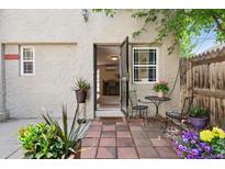 Back patio with an open doorway, plants, outdoor seating and brick flooring at 1532 N High St # 1, Denver, CO 80218
