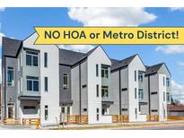 Modern townhome featuring a gray and white exterior, complemented by wooden fencing and 'NO HOA or Metro District' banner at 5385 W 14Th Ave, Lakewood, CO 80214