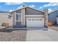 Charming home boasts a modern design, two-car garage and unique stone-accented chimney at 9314 Biscay St, Commerce City, CO 80022