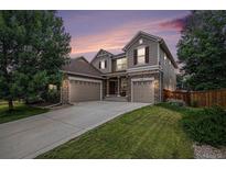 Charming two-story home with a three-car garage and well-manicured lawn at 14058 Elizabeth St, Thornton, CO 80602
