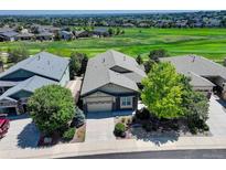 Beautifully landscaped home with a well-maintained yard backing onto a golf course at 15088 Verbena St, Thornton, CO 80602