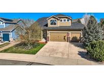 Inviting two-story home with a three-car garage and well-maintained landscaping at 7378 Geode Ct, Castle Rock, CO 80108