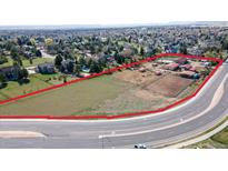 Expansive horse property featuring lush pasture, barn, and arena for equestrian enthusiasts at 5400 S Alkire St, Littleton, CO 80127