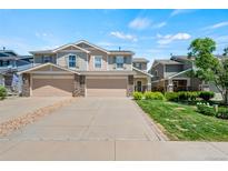 Charming townhome featuring stone accents, a two-car garage and well-maintained landscaping at 6139 Raleigh Cir, Castle Rock, CO 80104