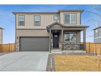 Charming two-story home featuring a two-car garage, covered porch and attractive curb appeal at 9929 Ceylon Ct, Commerce City, CO 80022