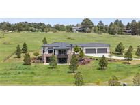 Beautiful two-story home with stone accents, three-car garage, balcony and professional landscaping at 2937 Hidden Den Ct, Franktown, CO 80116