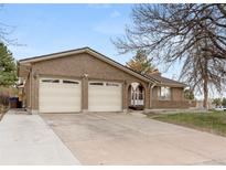Charming brick home featuring a two-car garage and an inviting front entrance, perfect for suburban living at 2696 S Yukon Ct, Lakewood, CO 80227
