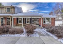 Brick ranch home with covered porch and landscaping at 8621 E Yale Ave # F, Denver, CO 80231