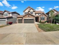 Charming two-story home with stone accents, three-car garage, and well-maintained landscaping at 2180 Trailblazer Way, Castle Rock, CO 80109