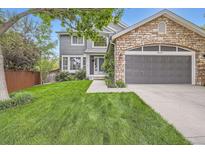 Charming two-story home with stone accents, lush lawn, and a well-maintained, inviting exterior at 16341 Maple Rock Ct, Parker, CO 80134