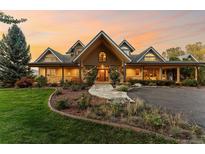 Inviting two-story home with lush landscaping, stone pathway, and covered porch at 5101 Saint Vrain Rd, Longmont, CO 80503