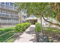 Inviting building entrance featuring manicured landscaping and a well-maintained walkway at 14390 E Marina Dr # 403, Aurora, CO 80014
