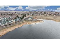 Aerial view of townhome community with pond, landscaping, and parking near walking trails at 1825 Spaulding Cir, Superior, CO 80027