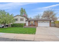 Charming split-level home with a well-manicured lawn and two-car garage at 5060 W 71St Pl, Westminster, CO 80030