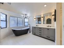 Modern bathroom featuring a freestanding tub, double sink vanity, and updated fixtures at 11892 Vallejo St, Denver, CO 80234