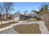 Charming single-Gathering home featuring stone accents, solar panels, attached garage, and landscaped front yard at 7819 W Portland Ave, Littleton, CO 80128