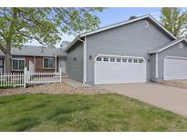 Charming home with a two-car garage, fenced yard, and well-maintained landscaping at 23 Shetland Ct, Highlands Ranch, CO 80130