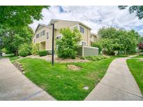 Inviting two-story townhouse with lush landscaping and a well-maintained lawn at 930 Button Rock Dr # 29, Longmont, CO 80504
