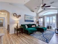 Spacious living room with vaulted ceilings and a green sectional sofa at 14221 E 1St Dr # 304, Aurora, CO 80011