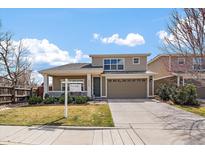 Charming two-story home with a well-manicured lawn and a 'For Sale' sign displayed prominently at 1250 W Quincy Cir, Englewood, CO 80110