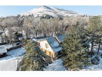 Stunning home nestled among snow covered trees with mountain views at 14080 Crabapple Rd, Golden, CO 80401