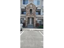 Attractive condo entrance featuring stone archway and well-maintained landscaping at 12711 Colorado Blvd # 1116, Thornton, CO 80241