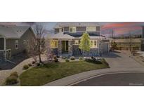 Beautiful two-story home featuring stone accents, manicured lawn, and a welcoming covered porch at 4220 Kestrel Dr, Broomfield, CO 80023