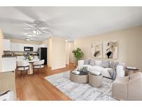 Bright living room featuring hardwood floors, a white sofa set, and stylish decor at 720 S Clinton St # 1B, Denver, CO 80247