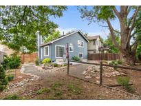 Charming home featuring a beautiful backyard area with rock garden, fence and patio seating at 13341 Birch Cir, Thornton, CO 80241