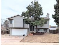 Charming two-story home with mature landscaping and a well-maintained front yard at 15018 E Greenwood Pl, Aurora, CO 80014