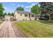 Charming single-story home with a well-maintained lawn, mature trees, and a long driveway leading to a detached garage at 2731 S Pearl St, Englewood, CO 80113