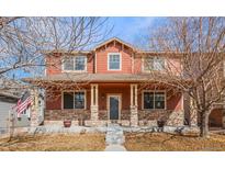 Charming two-story home with a covered porch and stone accents, located in a desirable neighborhood at 11034 Nome St, Commerce City, CO 80640