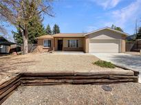 Charming single-story home with a well-manicured front yard and a two-car garage at 3986 S Bahama St, Aurora, CO 80013