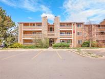 Condominium exterior featuring stone accents and well-maintained landscaping on a partly cloudy day at 1094 S Dearborn St # 301, Aurora, CO 80012