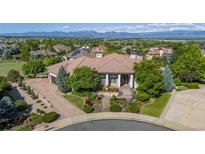 Expansive home exterior featuring professional landscaping, a circular driveway, and mountain views at 2378 Plumb Pl, Erie, CO 80516