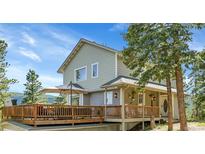 Stunning two-story house featuring a large deck perfect for outdoor entertaining at 6979 Weasel Way, Evergreen, CO 80439