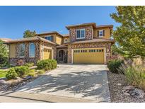 Stunning two-story home featuring a spacious driveway and attached garage at 10631 Autumnsong Ct, Highlands Ranch, CO 80126