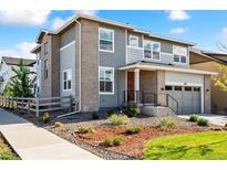 Charming two-story home with a well-maintained yard, modern brick, gray siding, and a two-car garage at 8102 S Adams Fork Ave, Littleton, CO 80125