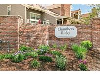 Chambers Ridge community entrance with a brick wall and beautiful landscaping at 1950 S Helena St # D, Aurora, CO 80013