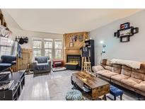Open living area featuring hardwood floors and a fireplace at 1192 S Zeno Way # E, Aurora, CO 80017