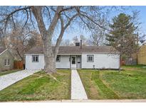 Charming single-story home with a well-maintained lawn and mature trees at 3342 S Flamingo Way, Denver, CO 80222