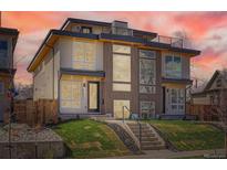 Modern duplex featuring a rooftop deck, large windows, and a well-manicured front yard at 4211 Vallejo St, Denver, CO 80211