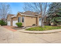 Charming townhome featuring a well-maintained lawn and attached two-car garage at 12610 E Wesley Pl, Aurora, CO 80014